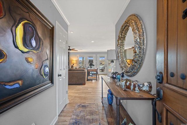 hallway featuring light wood finished floors, recessed lighting, and crown molding