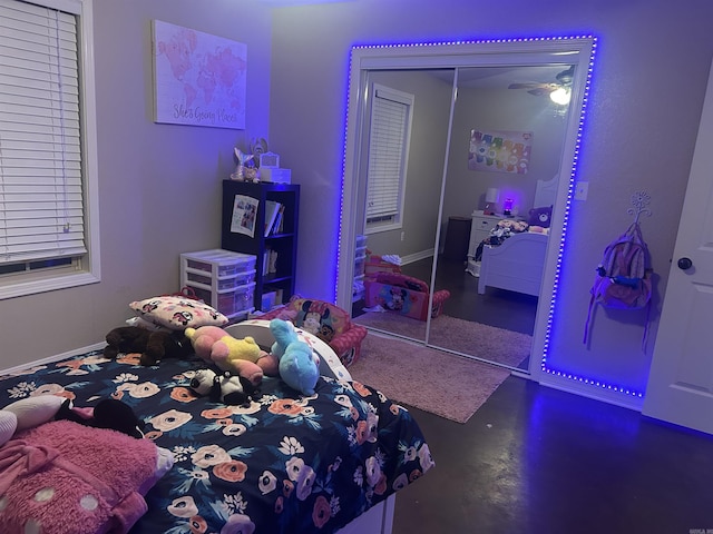 bedroom with a closet and finished concrete floors