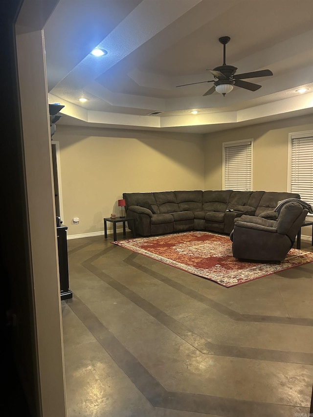 living area featuring baseboards, a raised ceiling, a ceiling fan, and recessed lighting