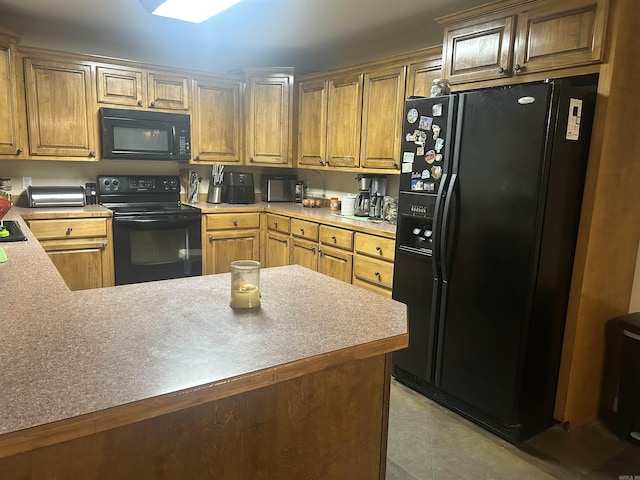 kitchen with light tile patterned flooring, a peninsula, light countertops, black appliances, and brown cabinetry