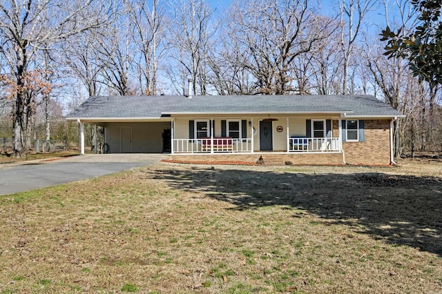 ranch-style home featuring driveway, a front yard, a porch, a carport, and brick siding