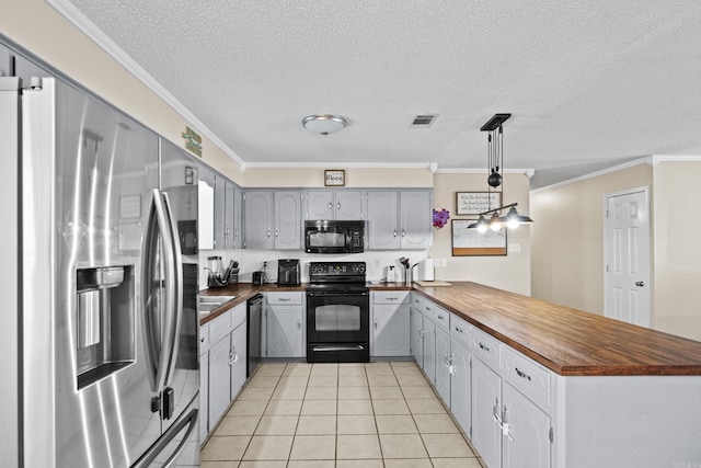 kitchen with black appliances, a peninsula, wooden counters, and gray cabinetry