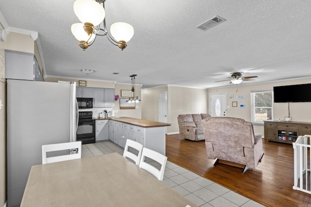 kitchen with visible vents, open floor plan, gray cabinets, black microwave, and range with electric stovetop