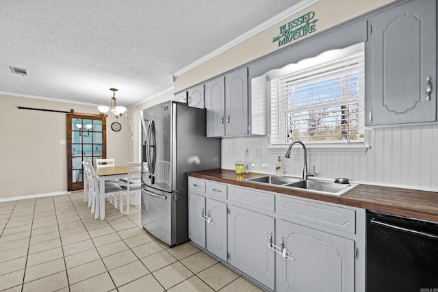 kitchen with visible vents, stainless steel fridge with ice dispenser, wood counters, gray cabinets, and a sink