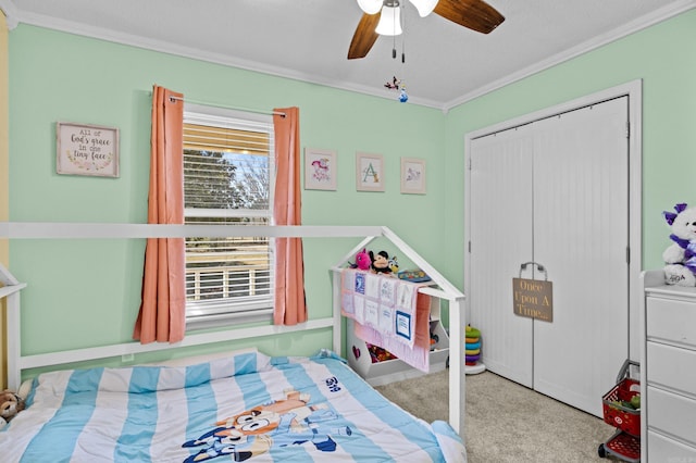 bedroom with light carpet, a ceiling fan, a textured ceiling, crown molding, and a closet