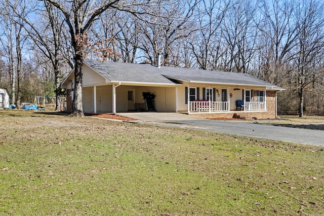 ranch-style house with aphalt driveway, a porch, an attached carport, and a front yard