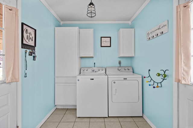 clothes washing area with cabinet space, light tile patterned floors, ornamental molding, and separate washer and dryer