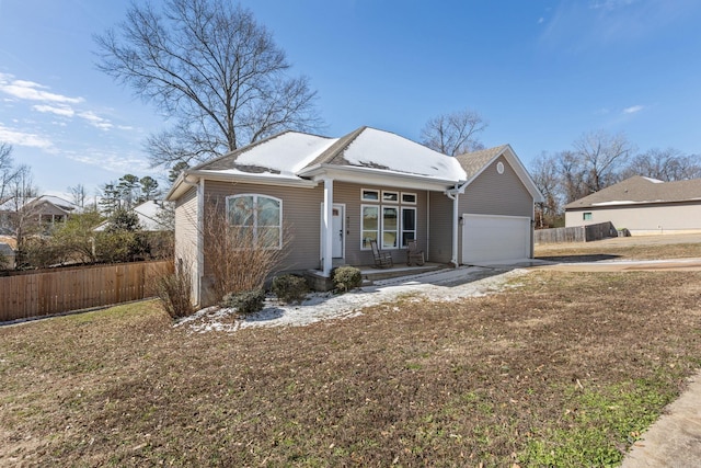 view of front of property featuring a porch, a garage, fence, driveway, and a front yard