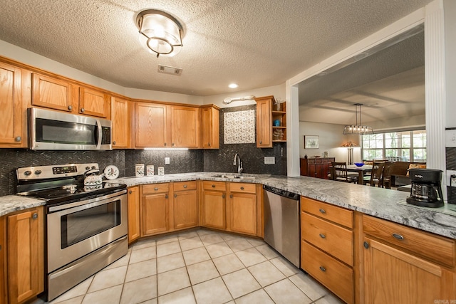 kitchen featuring a sink, visible vents, appliances with stainless steel finishes, open shelves, and brown cabinetry