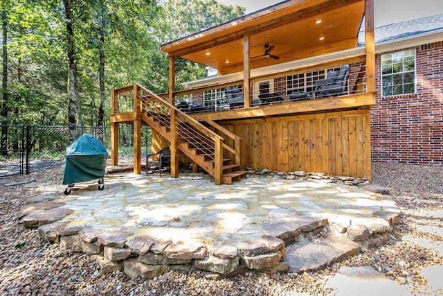 view of patio featuring a ceiling fan, fence, stairway, and grilling area