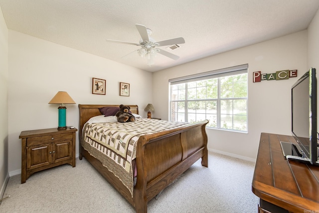 bedroom featuring light colored carpet, visible vents, ceiling fan, a textured ceiling, and baseboards