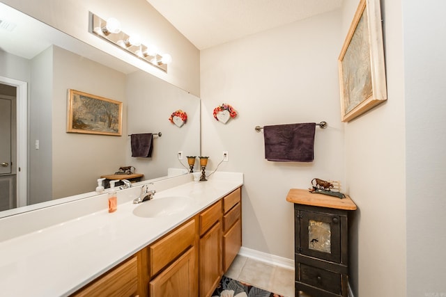 bathroom featuring tile patterned flooring, baseboards, and vanity