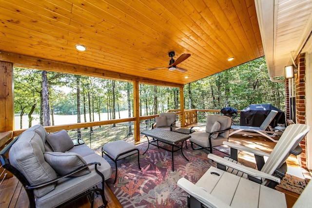 sunroom / solarium featuring ceiling fan, a water view, and wood ceiling