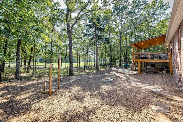 view of yard with fence, stairway, and a wooden deck