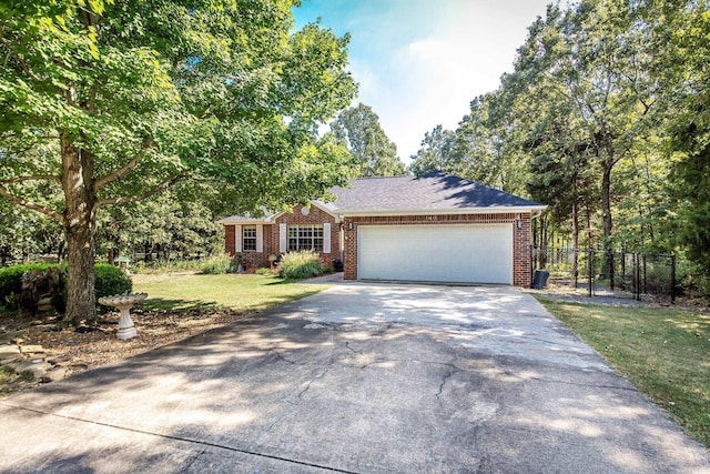 ranch-style home featuring a garage, brick siding, fence, driveway, and a front yard