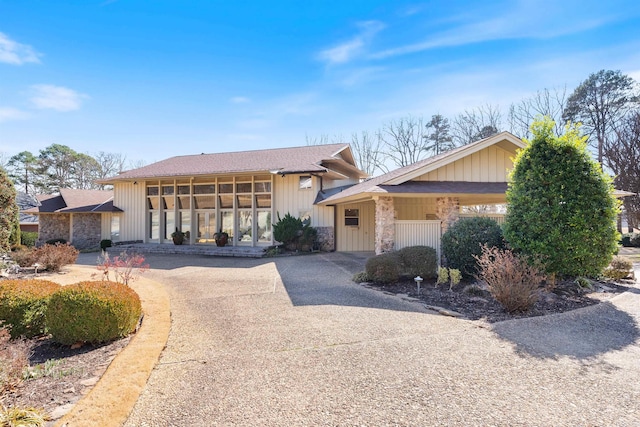 view of front of property with stone siding and driveway