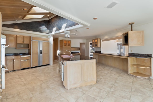 kitchen featuring an island with sink, lofted ceiling with skylight, ceiling fan, paneled refrigerator, and open shelves