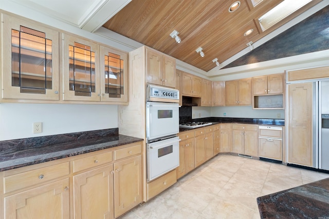 kitchen with wooden ceiling, white appliances, dark stone counters, light brown cabinetry, and glass insert cabinets