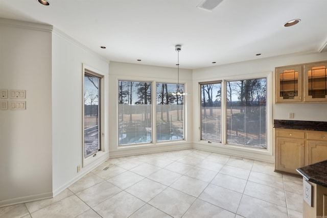 unfurnished dining area with ornamental molding, recessed lighting, baseboards, and light tile patterned floors