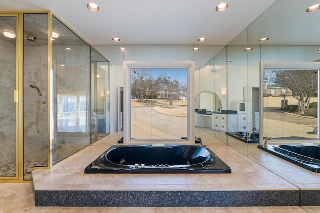 bathroom with a garden tub, a shower stall, and recessed lighting