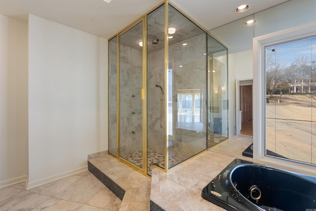 bathroom with recessed lighting, a garden tub, a shower stall, and baseboards