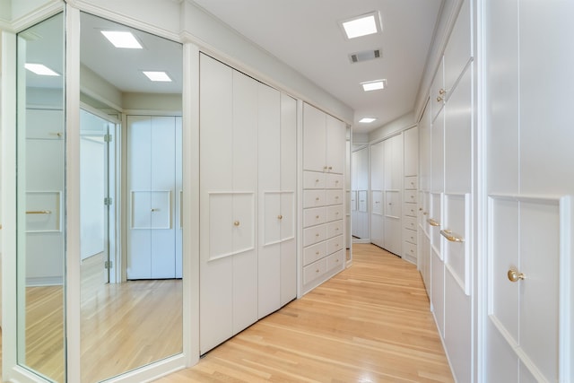 walk in closet with light wood-style flooring and visible vents