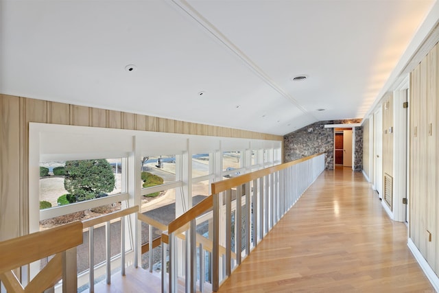 hall featuring lofted ceiling and light wood-type flooring