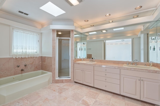 bathroom with a stall shower, visible vents, and a sink