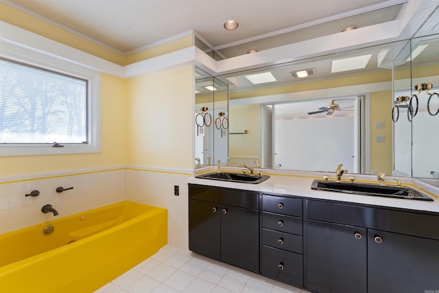 bathroom featuring a garden tub, double vanity, and a sink