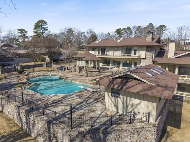 view of pool featuring a fenced in pool, a patio area, fence, and a diving board