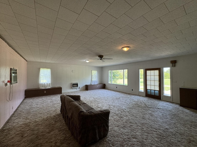 living room featuring heating unit, carpet, and ceiling fan