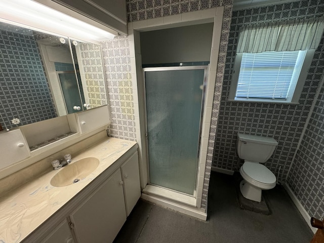 full bathroom with a stall shower, vanity, and toilet