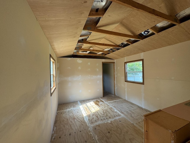 unfurnished room with lofted ceiling