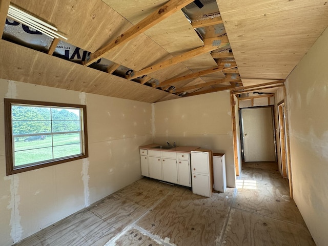 kitchen featuring white cabinets and a sink