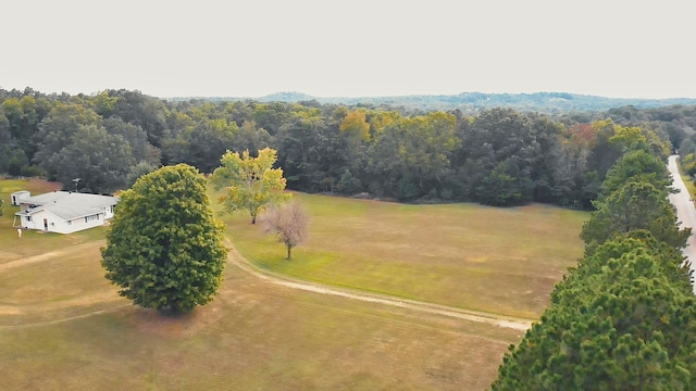 aerial view featuring a wooded view and a rural view