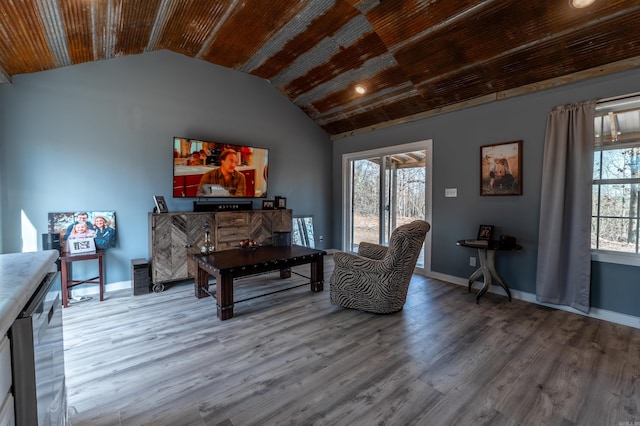 living area with lofted ceiling, wooden ceiling, baseboards, and wood finished floors