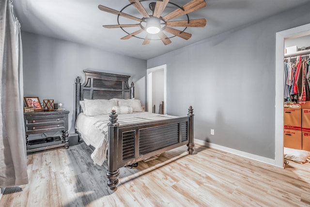 bedroom featuring a ceiling fan, baseboards, and wood finished floors