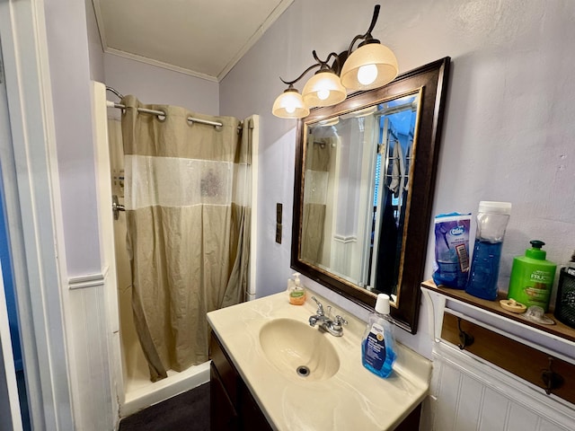 full bathroom with ornamental molding, shower / bath combo with shower curtain, and vanity