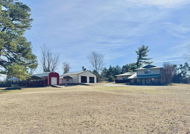 view of yard featuring an outbuilding and a detached garage