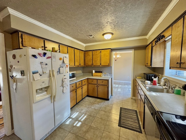 kitchen featuring white appliances, brown cabinets, light countertops, crown molding, and a sink