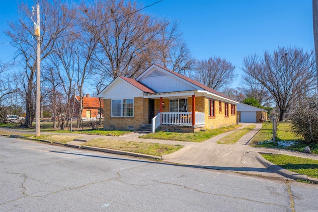 view of front facade with crawl space, covered porch, a front yard, and brick siding