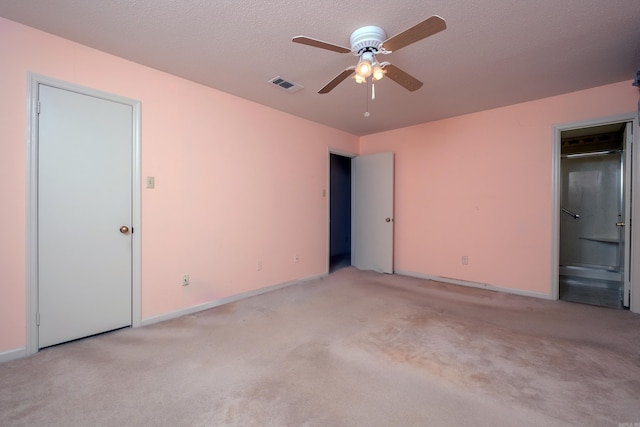 empty room featuring ceiling fan, baseboards, visible vents, and light colored carpet