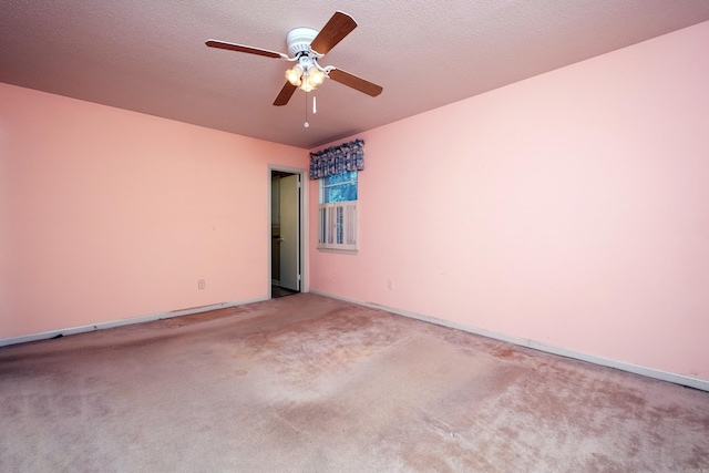 spare room featuring ceiling fan, a textured ceiling, baseboards, and carpet flooring