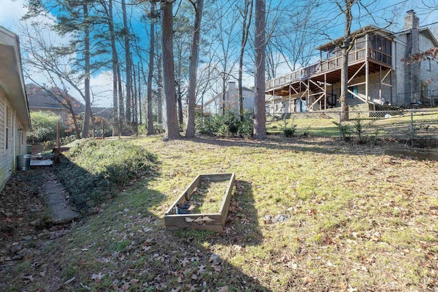 view of yard featuring fence and a vegetable garden