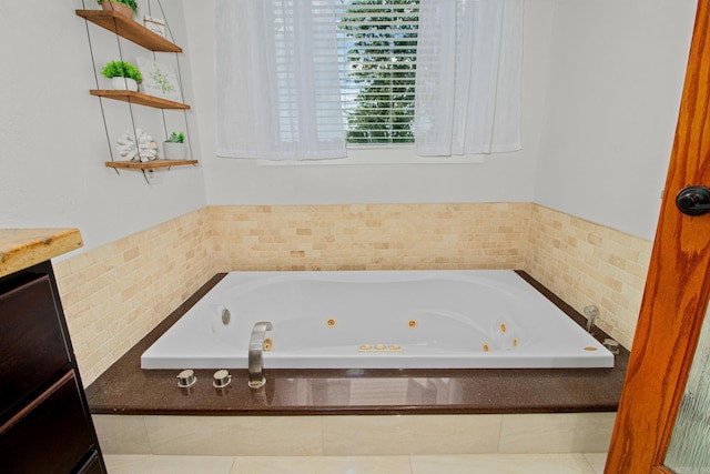 bathroom featuring a tub with jets and vanity