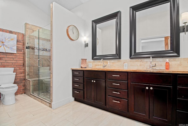 full bath featuring a sink, a shower stall, toilet, and double vanity