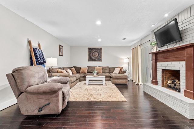 living room featuring recessed lighting, a brick fireplace, visible vents, and dark wood finished floors