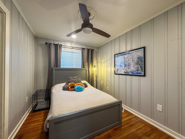 bedroom with ornamental molding, dark wood finished floors, baseboards, and a ceiling fan