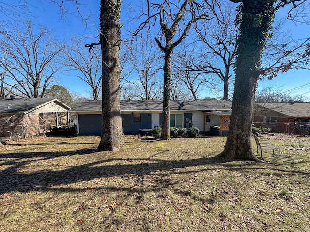 view of front of house with fence and a front lawn