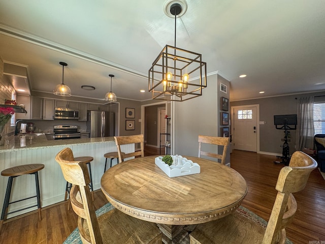 dining area with dark wood-type flooring, recessed lighting, visible vents, and crown molding